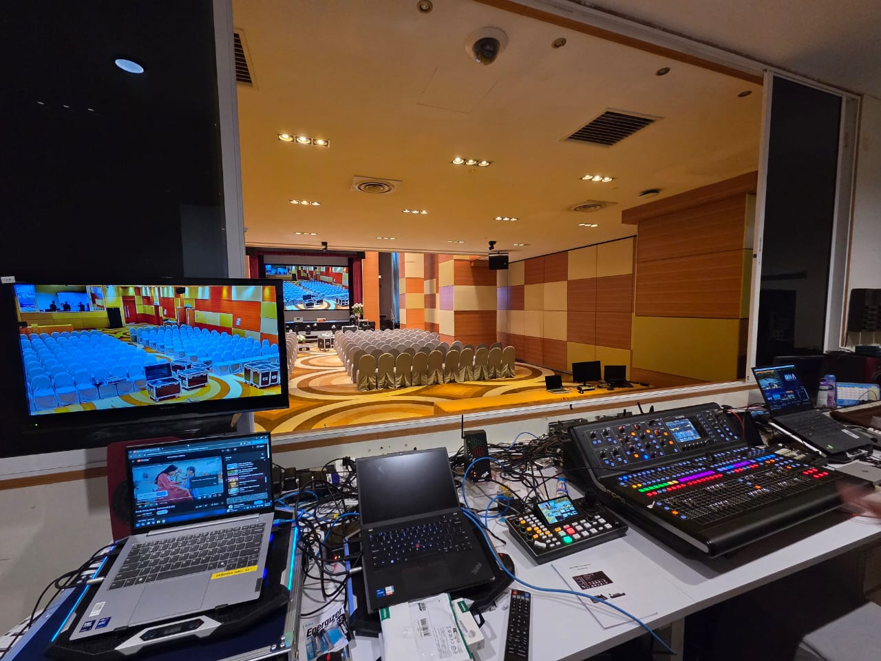 Two-laptop control booth overlooking an auditorium